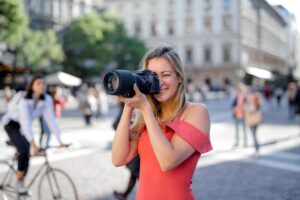 woman taking photo using black camera