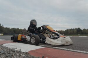 person driving a go kart in racetrack